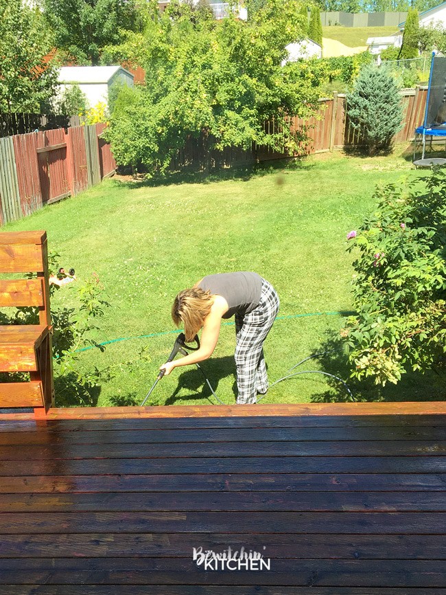 How to stain a deck in 4 easy steps. This DIY deck renovation uses Behr's Premium Deck Stripper, Wood Cleaner and Semi-Transparent Stain in Redwood Naturaltone. The before and after looks incredible!