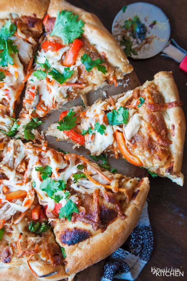 Thai Chicken Pizza - quick and easy recipe that's perfect for busy weeknights. Ready in under 30 minutes. Peanut thai sauce, chicken, carrots, cilantro and red pepper with THE BEST pizza crust recipe as a base.