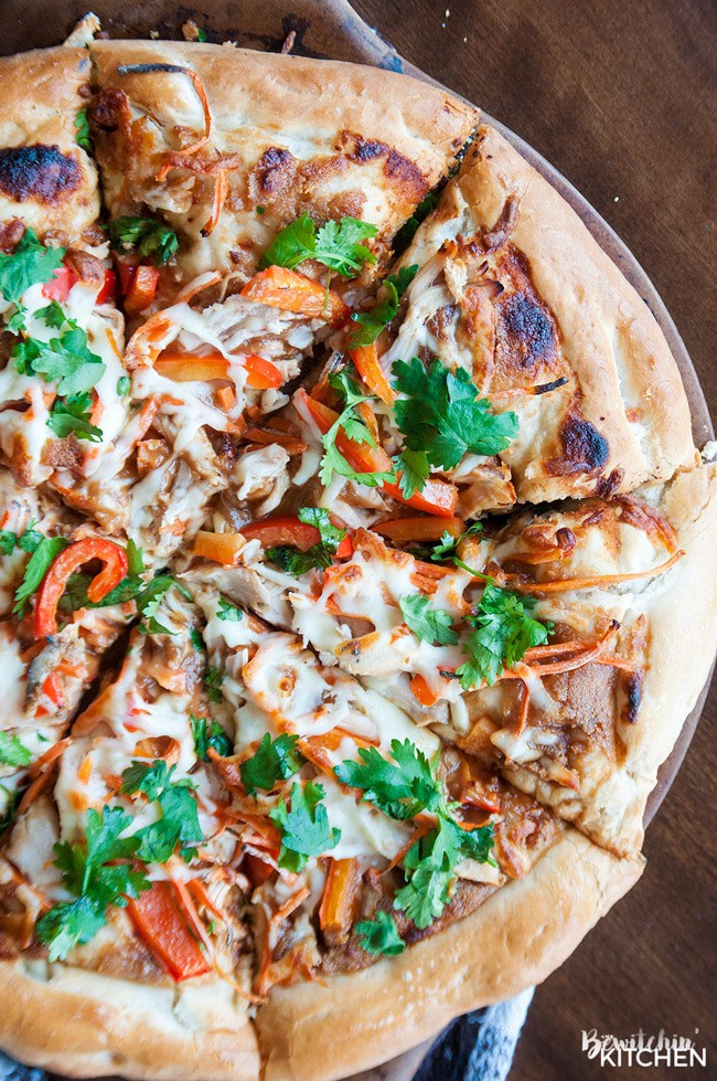 Thai Chicken Pizza - quick and easy recipe that's perfect for busy weeknights. Ready in under 30 minutes. Peanut thai sauce, chicken, carrots, cilantro and red pepper with THE BEST pizza crust recipe as a base.
