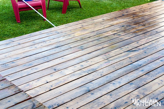 How to stain a deck in 4 easy steps. This DIY deck renovation uses Behr's Premium Deck Stripper, Wood Cleaner and Semi-Transparent Stain in Redwood Naturaltone. The before and after looks incredible!