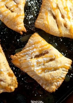 apple turnovers with powdered sugar and caramel drizzle
