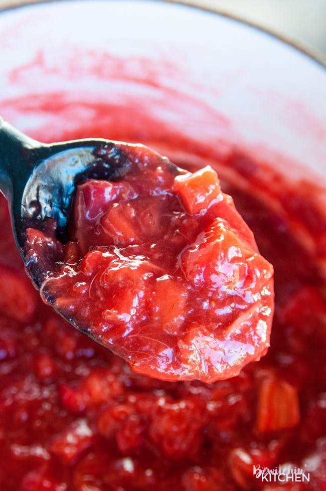 large spoon with a scoop of rhubarb pie filling over a pot