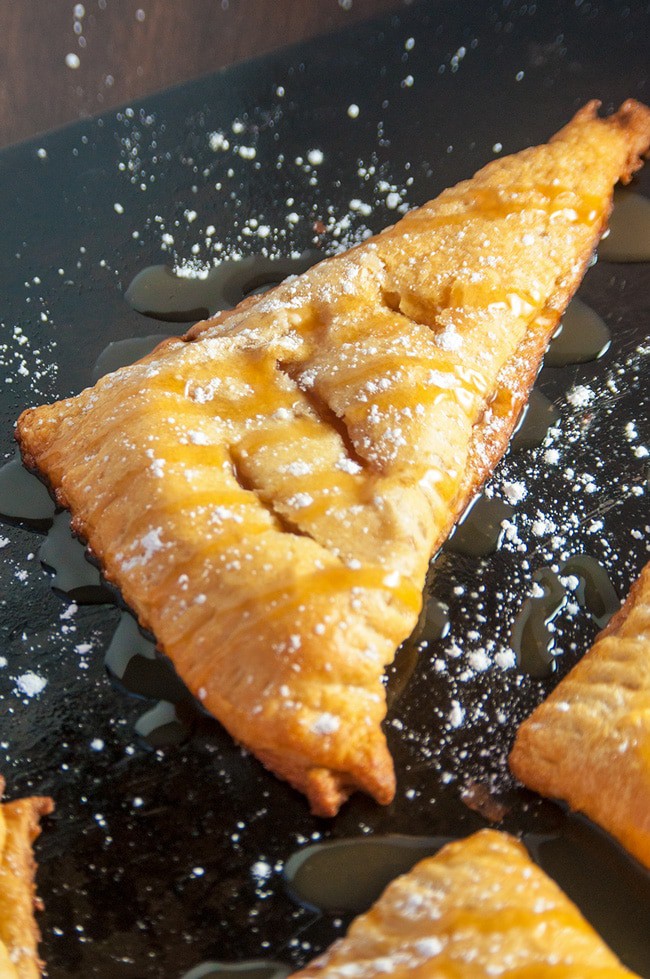 triangle apple turnover with powdered sugar and caramel