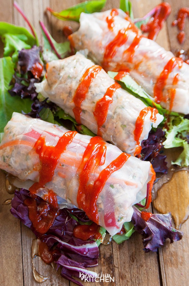 Honey Sriracha Chicken Spring Rolls - this slow cooker dinner recipe uses rice paper wrappers and is not only gluten free but paleo and 21 day fix approved as well. | TheBewitchinKitchen.com