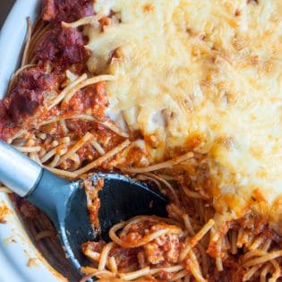 This skinny baked spaghetti recipe is a lightened up version of a classic spaghetti casserole. Both healthy and hearty, this wholesome dinner recipe favorite uses ancient grain pasta and the best spaghetti sauce ever. This sauce has tons of vegetables, light cheese (part skim mozzarella), and both ground turkey and turkey Italian sausage. A healthy baked spaghetti recipe is within reach, add it to your meal plan!