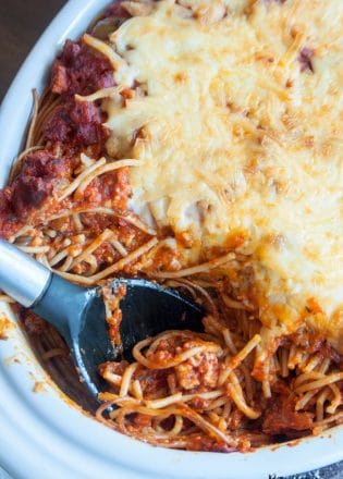 This skinny baked spaghetti recipe is a lightened up version of a classic spaghetti casserole. Both healthy and hearty, this wholesome dinner recipe favorite uses ancient grain pasta and the best spaghetti sauce ever. This sauce has tons of vegetables, light cheese (part skim mozzarella), and both ground turkey and turkey Italian sausage. A healthy baked spaghetti recipe is within reach, add it to your meal plan!