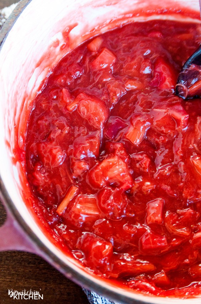 stirring a pot of strawberry rhubarb pie filling