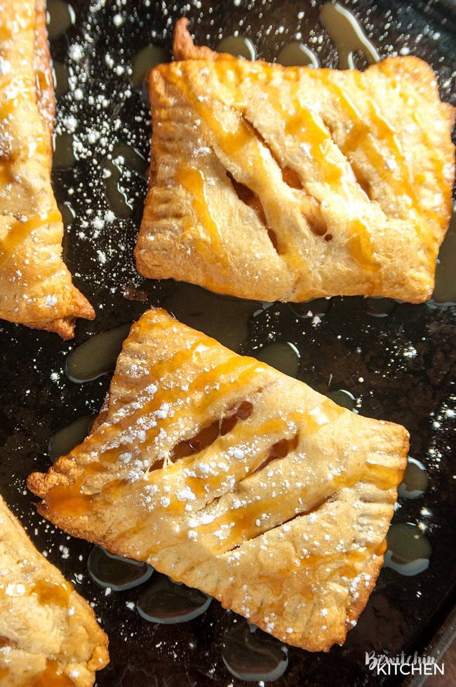 homemade apple hand pies with powdered sugar and caramel drizzle