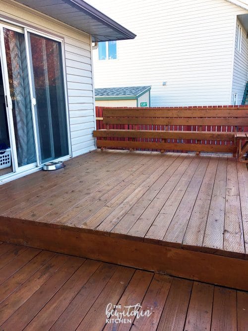 How to stain a deck in 4 easy steps. This DIY deck renovation uses Behr's Premium Deck Stripper, Wood Cleaner and Semi-Transparent Stain in Redwood Naturaltone. The before and after looks incredible!