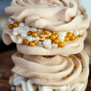 Christmas Meringues filled with an eggnog buttercream frosting. A delicious dessert that is sure to be a hit at holiday parties. They're easy to make too!