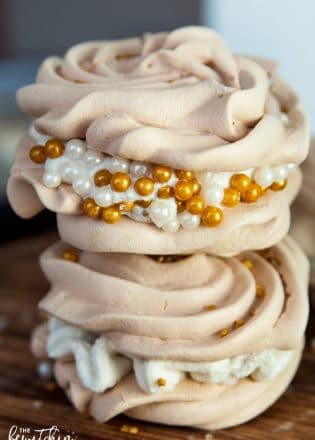 Christmas Meringues filled with an eggnog buttercream frosting. A delicious dessert that is sure to be a hit at holiday parties. They're easy to make too!