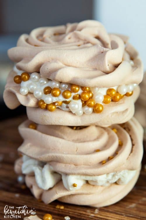 Christmas Meringues filled with an eggnog buttercream frosting. A delicious dessert that is sure to be a hit at holiday parties. They're easy to make too! 