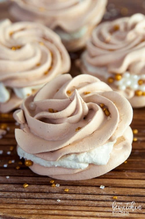 Christmas Meringues filled with an eggnog buttercream frosting. A delicious dessert that is sure to be a hit at holiday parties. They're easy to make too! 