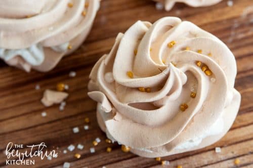 Christmas Meringues filled with an eggnog buttercream frosting. A delicious dessert that is sure to be a hit at holiday parties. They're easy to make too! 