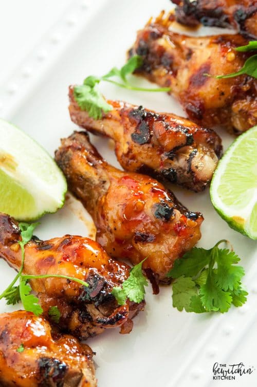 Spicy Thai Chicken Wings - a sweet twist on hot wings using thai chili sauce, limes, sriracha and a few other secret ingredients. A new favorite appetizer for the game, tailgating or a party.