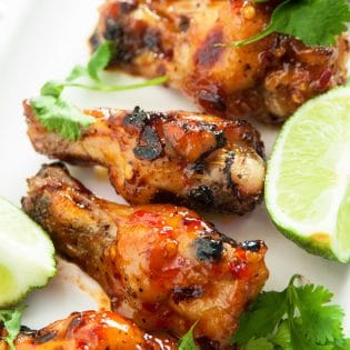 Spicy Thai Chicken Wings - a sweet twist on hot wings using thai chili sauce, limes, sriracha and a few other secret ingredients. A new favorite appetizer for the game, tailgating or a party.