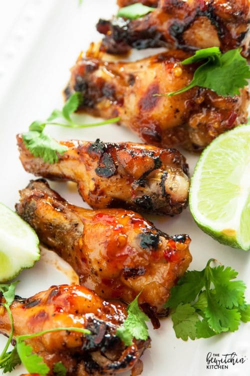 Spicy Thai Chicken Wings - a sweet twist on hot wings using thai chili sauce, limes, sriracha and a few other secret ingredients. A new favorite appetizer for the game, tailgating or a party.