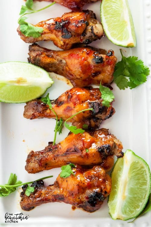 Spicy Thai Chicken Wings - a sweet twist on hot wings using thai chili sauce, limes, sriracha and a few other secret ingredients. A new favorite appetizer for the game, tailgating or a party.