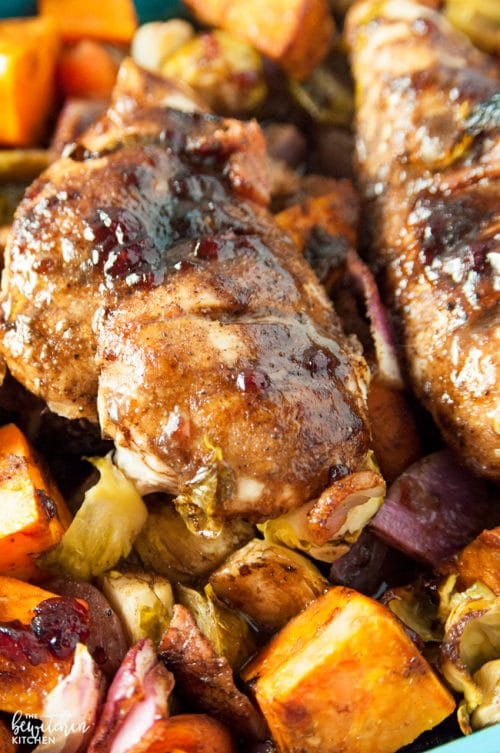 Cranberry balsamic chicken breasts with roasted vegetables. A healthy dinner recipe that uses up leftover cranberry sauce!