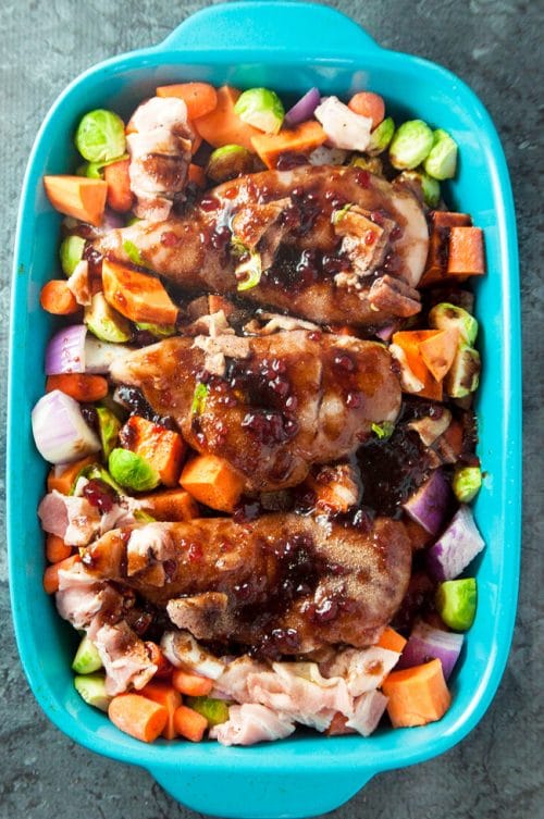 Cranberry balsamic chicken breasts with roasted vegetables. A healthy dinner recipe that uses up leftover cranberry sauce!