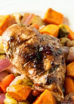 Cranberry balsamic chicken breasts with roasted vegetables. A healthy dinner recipe that uses up leftover cranberry sauce!