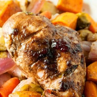 Cranberry balsamic chicken breasts with roasted vegetables. A healthy dinner recipe that uses up leftover cranberry sauce!