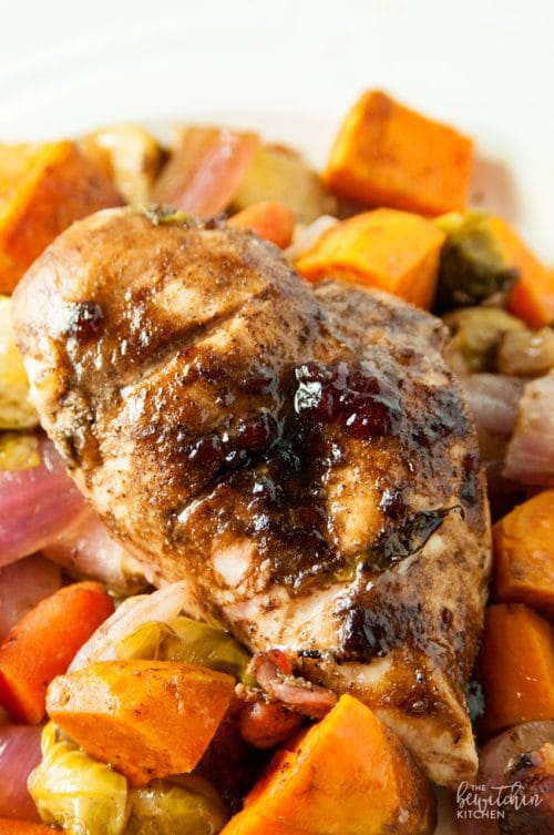 Cranberry balsamic chicken breasts with roasted vegetables. A healthy dinner recipe that uses up leftover cranberry sauce!