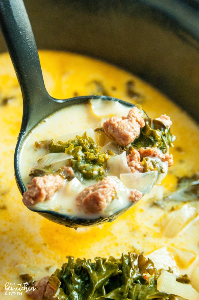 closeup: a ladle full of zuppa toscana over a crock pot 