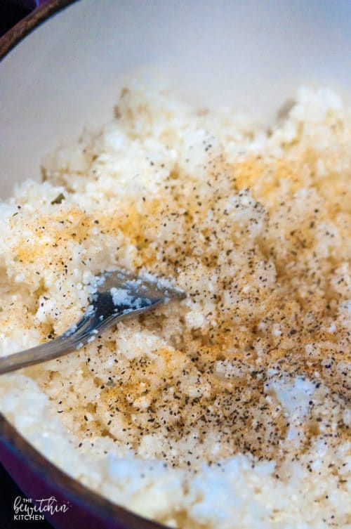 Seasoning the cauliflower rice to ensure it matches the main course.