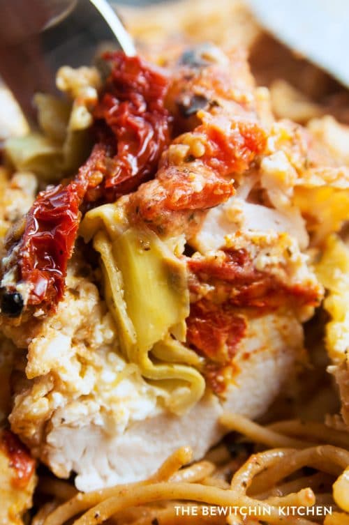 Sundried tomato stuffed chicken breasts with a creamy tomato parmesan sauce. This chicken breast recipe is stuffed with sundried tomatoes, cream cheese, and artichokes. Delicious served over pasta or with a healthy side salad for dinner.