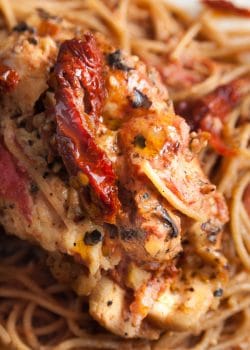 Sundried tomato stuffed chicken breasts with a creamy tomato parmesan sauce. This chicken breast recipe is stuffed with sundried tomatoes, cream cheese, and artichokes. Delicious served over pasta or with a healthy side salad for dinner.