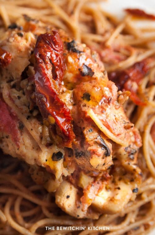 Sundried tomato stuffed chicken breasts with a creamy tomato parmesan sauce. This chicken breast recipe is stuffed with sundried tomatoes, cream cheese, and artichokes. Delicious served over pasta or with a healthy side salad for dinner.