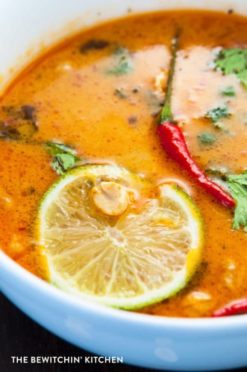 bowl of Thai peanut soup with lime and chilis