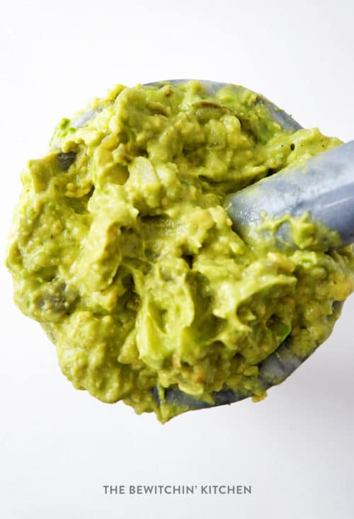 authentic guacamole recipe mashed together in a mortar and pestle.