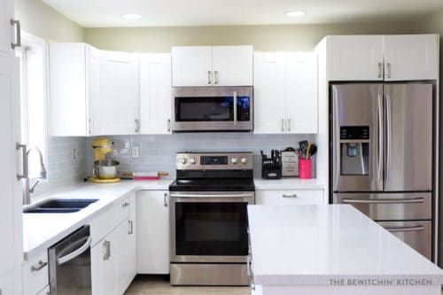 This all white kitchen was the result of a DIY kitchen renovation. Using Home Depot's Eurostyle Kitchen Cabinets in Oxford and Silestone's Stellar Snow. The back splash is Sassi's glass subway tile in nordic ice. More before and after photos in the post.