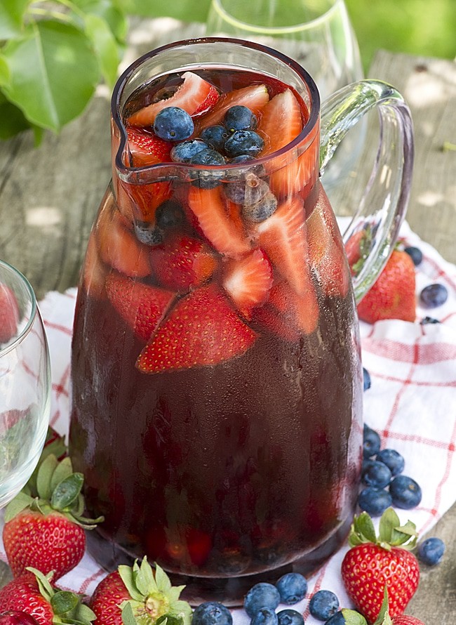 A white wine sangria that uses steeped berry tea! Load the pitcher with summer berries! This sweet tea berry sangria is the ultimate summer cocktail!