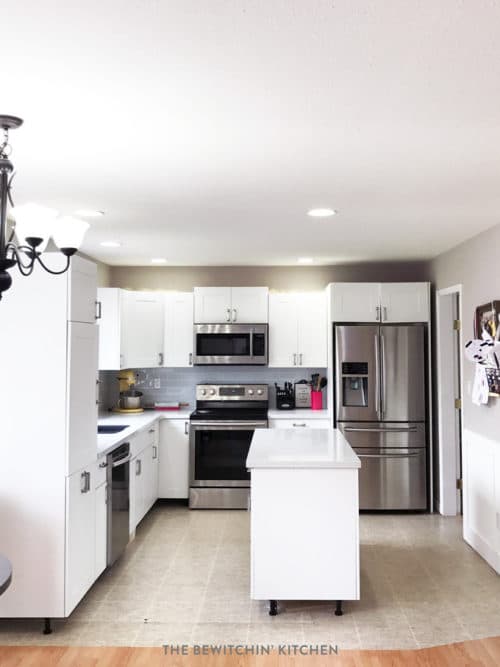 This all white kitchen was the result of a DIY kitchen renovation. Using Home Depot's Eurostyle Kitchen Cabinets in Oxford and Silestone's Stellar Snow. The back splash is Sassi's glass subway tile in nordic ice. More before and after photos in the post.