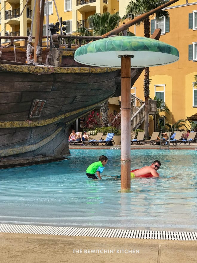 Father and son playing in the pirate ship pool at Lake Buena Vista