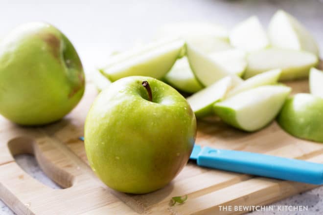 granny smith apple on a cutting board