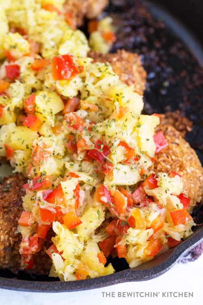 Coconut crusted chicken topped with pineapple salsa