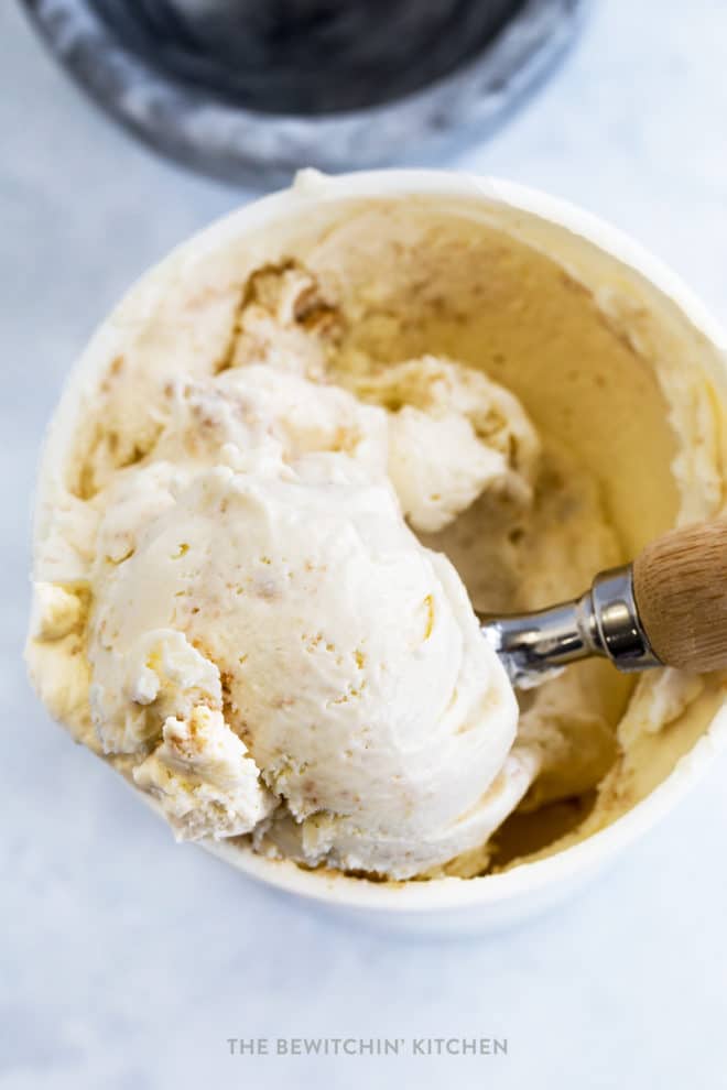 Overhead shot of key lime pie ice cream being scooped out of a container.