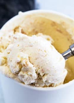 No churn key lime pie ice cream being scooped out of a reusable ice cream container.