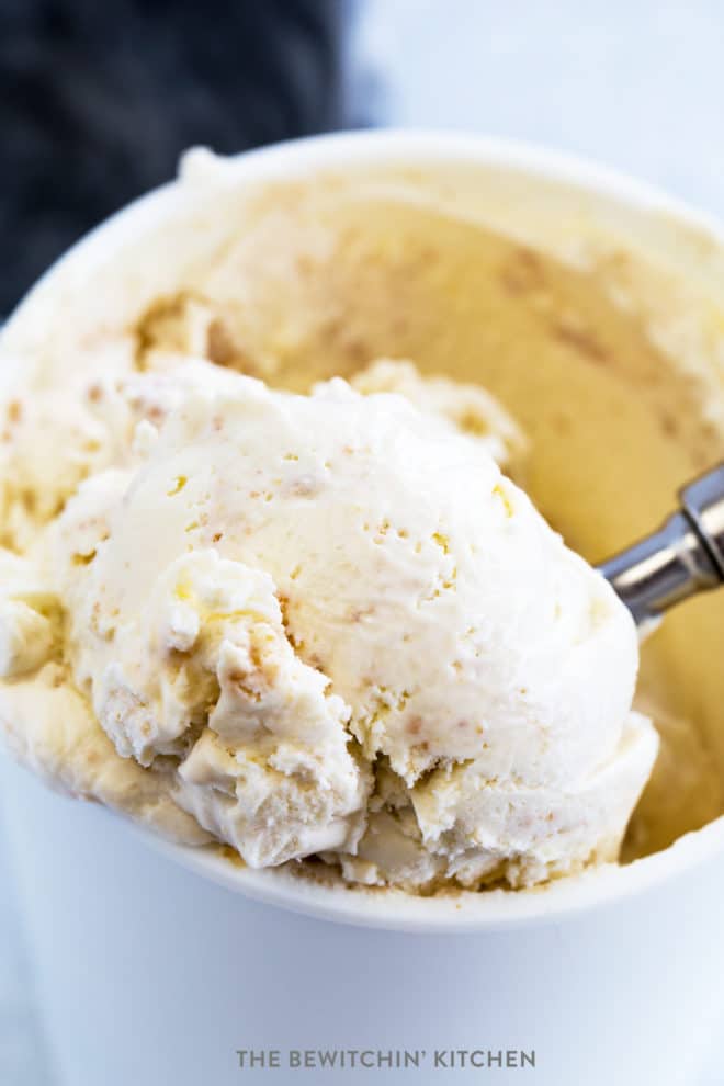 No churn key lime pie ice cream being scooped out of a reusable ice cream container.