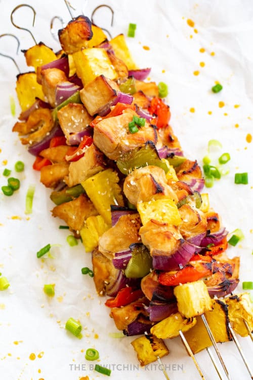 pineapple chicken kebabs stacked on a steel skewer