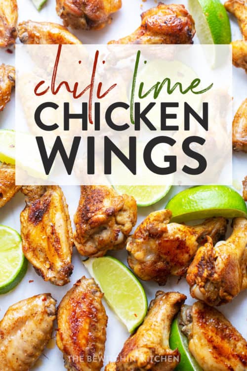 Chili lime chicken wings spread out with lime wedges