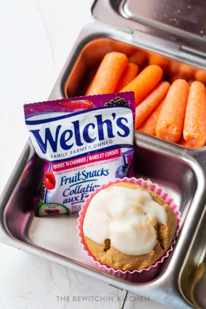 Easy kids lunch ideas - Welch's Fruit Snacks beside a healhy cinnamon roll muffin in a PlanetBox with baby carrots in the background.
