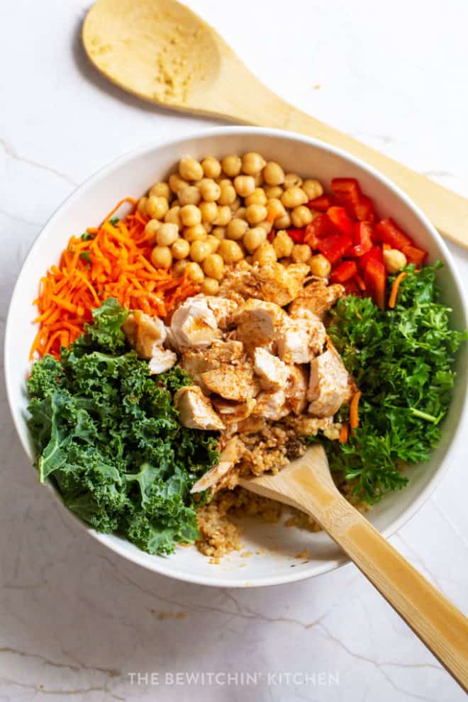 Kale carrot salad bowl dressed with a moroccan vinaigrette.