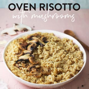 oven risotto with mushrooms in a bowl on a pink background