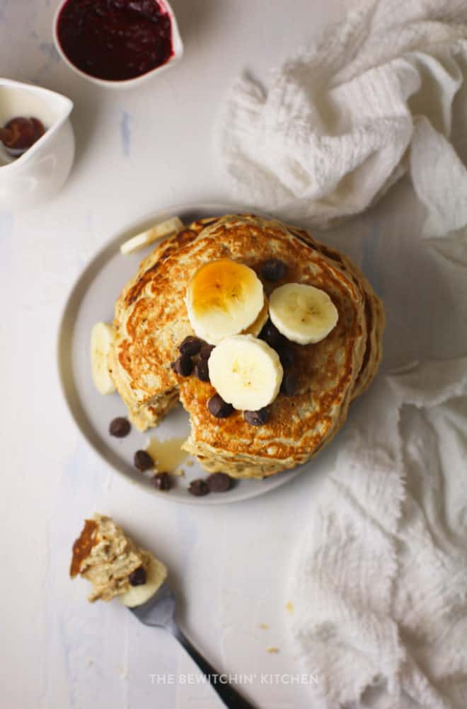 overhead view of healthy freezer pancakes topped with blueberries, bananas, and maple syrup