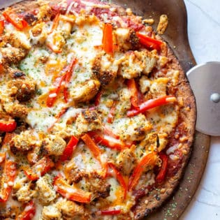 homemade chicken parmesan pizza on a hot pizza stone